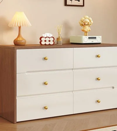 Modern White Wood Dresser with Drawers for Bedroom – Elegant Storage with Timeless Appeal Enhance your bedroom with the Modern White Wood Dresser with Drawers, a perfect blend of elegance, functionality, and modern design. This stylish dresser not only provides ample storage space but also adds a touch of sophistication to any bedroom décor. Moreover, its clean white finish and sturdy wooden structure make it a long-lasting and visually appealing furniture piece. Contemporary and Versatile Design Featuring a minimalist modern look, this dresser fits effortlessly into a variety of bedroom styles—from Scandinavian to classic contemporary. Additionally, its smooth white surface and refined edges create a calm and inviting atmosphere. Therefore, it’s ideal for both master bedrooms and guest rooms seeking a neat, elegant aesthetic. Durable Wooden Construction Built from high-quality wood, this dresser ensures strength and stability for years of reliable use. Furthermore, its smooth drawer slides and robust frame guarantee durability and everyday functionality. As a result, the Modern White Wood Dresser delivers both beauty and performance. Spacious Storage for Everyday Essentials The dresser comes with multiple wide drawers, providing ample space for organizing clothing, accessories, and personal items. In addition, the drawers glide smoothly, allowing effortless access to stored items. Consequently, it helps you maintain a clean and organized bedroom while keeping everything within reach. Features of the Modern White Wood Dresser with Drawers High-Quality Wooden Build: Ensures long-lasting durability and stability. Elegant White Finish: Adds a modern, refreshing look to any bedroom. Spacious Drawers: Perfect for storing clothes, linens, and accessories. Smooth-Glide Drawer System: Allows easy and quiet opening and closing. Flat Top Surface: Ideal for displaying décor, lamps, or mirrors. Versatile Design: Complements modern, classic, and minimalist interiors. Perfect for Bedroom Organization and Style Because of its balanced mix of beauty and practicality, this white wood dresser enhances your bedroom’s functionality while maintaining a sleek look. Moreover, it serves as both a storage solution and a stylish focal point in your room. Therefore, it’s perfect for anyone looking to upgrade their bedroom furniture with elegance and purpose. Easy to Maintain and Long-Lasting In addition to its stylish appeal, this dresser is easy to clean and maintain. Simply wipe the surface with a soft cloth to keep it looking new. Furthermore, its durable finish resists scratches and stains, ensuring that it stays beautiful for years. Consequently, it’s a reliable investment for long-term bedroom organization. A Blend of Beauty, Function, and Durability Ultimately, the Modern White Wood Dresser with Drawers for Bedroom is designed to meet all your storage and style needs. Its contemporary design, ample storage capacity, and strong craftsmanship make it a standout piece for any home. Upgrade your bedroom today with this elegant dresser—where modern design meets timeless functionality.